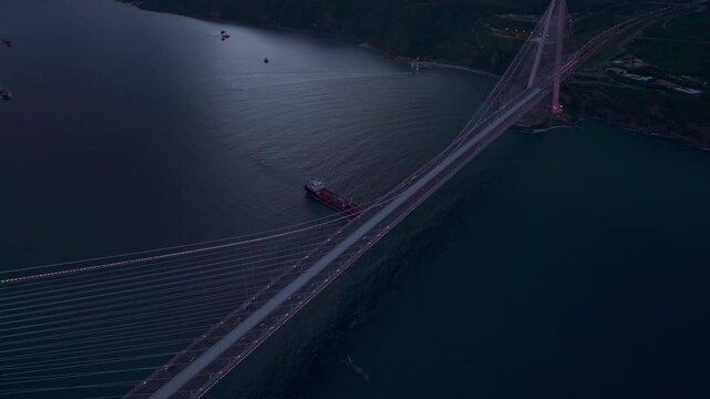Aerial view of yavuz sultan selim bridge at sunset over bosphorus strait with cargo ships, istanbul, turkey.