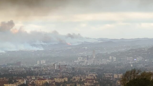 Aerial of massive wildfires burning across the hills of Los Angeles