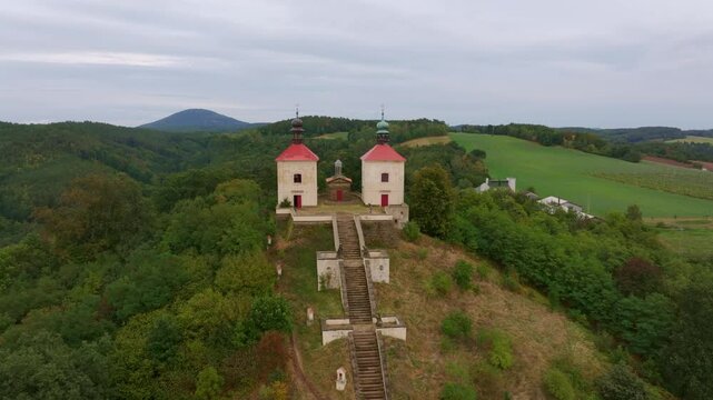 Aerial view of Calvary Ostre church surrounded by trees and hills, Ustek, Czech Republic.