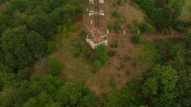 Aerial view of Calvary Ostre church surrounded by trees and forest, Ustek, Czech Republic.