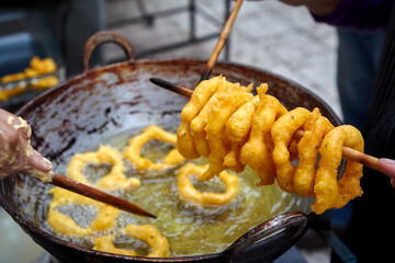 Peruvian picarones are a traditional dessert commonly found in Peru. They are a type of doughnut made from a sweet potato and pumpkin batter, which is deep-fried until golden brown.