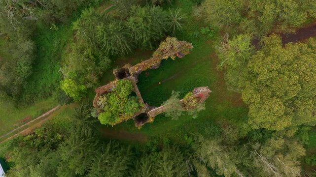 Aerial view of the ruins of St. Jana Krtitele surrounded by lush green forest, Kocov, Czech Republic.