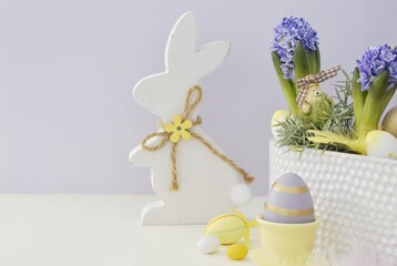 Easter card with a bunny, Easter eggs and hyacinths. Copy space.