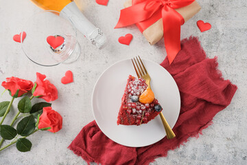 red velvet cake with fruit for valentines day on white table setting, copy space