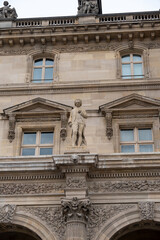 Sculpture on the facade of a historic building with intricate architecture in the heart of a famous city