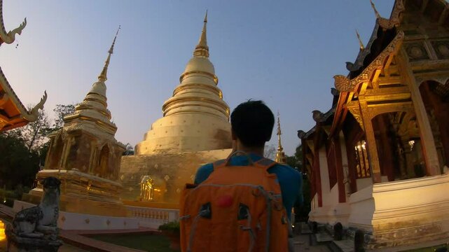 A peaceful scene capturing the beauty of a temple at dusk. Golden pagodas shine under the fading light, creating a tranquil atmosphere that invites reflection and spiritual connection in this serene s