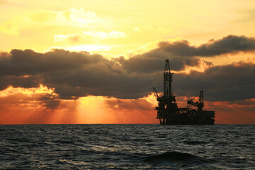 Oil and rig in offshore with sunset and sunrise time. The construction platform for production oil...