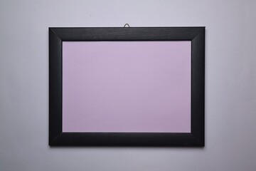 Wooden frame with purple surface isolated on white background. 