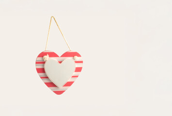heart shaped hanging valentines card note on a rope with message area in pink and white isolated on a white background