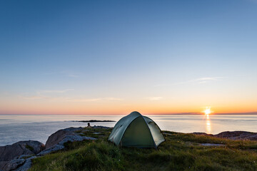 Camping in tent with Midnight sun and sea in Norway over the sea in Andoya, Nordland, Norway © Marius Karp
