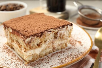 Piece of tasty tiramisu on table, closeup