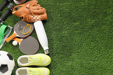Different sports equipment on artificial grass, flat lay. Space for text