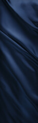 Obraz premium Deep dark navy blue silk with a satin finish, gently folded to create soft, flowing lines and a subtle color gradient. Elegant, luxurious background for refined designs.