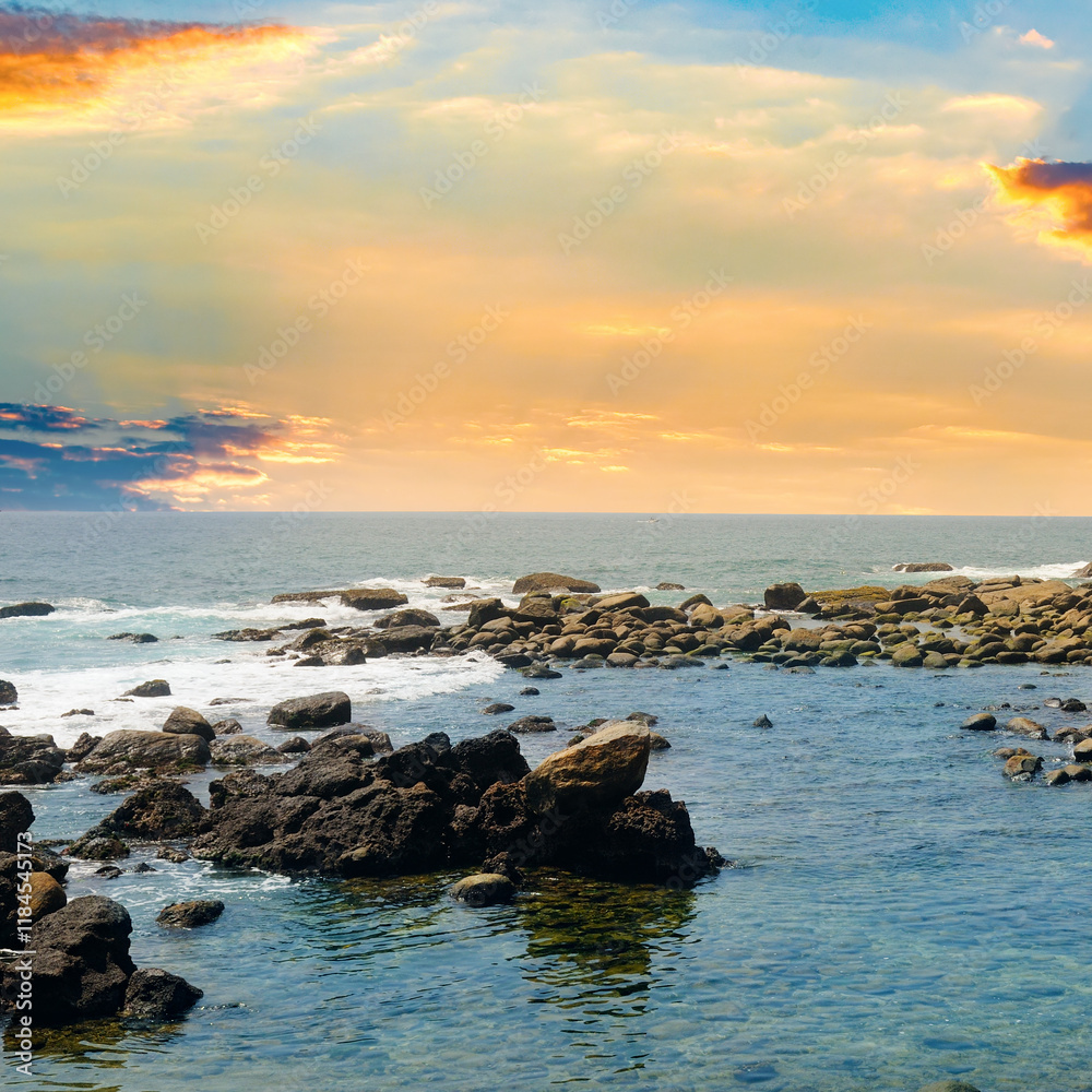 Poster Seascape with beautiful waves, rocky shore and bright sunrise.