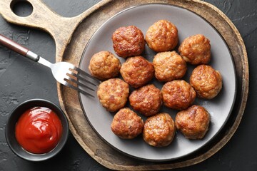 Tasty meatballs served on grey table, flat lay