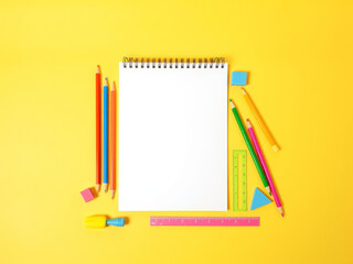 Blank Spiral Notebook with Colorful Pencils, Ruler, and Erasers: A Cheerful Back-to-School Composition