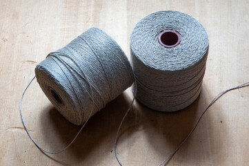 spools of twine rope on a wooden table