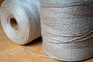 spools of twine rope on wooden table, close-up