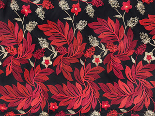 Sewn 3d fabric in red leaves and flowers pattern, with gold color branch and petals. Red and gold random floral and foliage theme shape. Seamless background texture. © TMR Studio