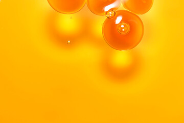 Transparent bubbles on bright yellow background creating a vibrant effect