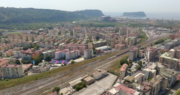 Aerial view of the Coroglio area in Naples, Italy. In the background is the island of Nisida and the Tyrrhenian Sea.