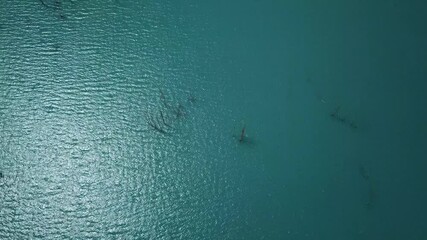 Aerial view of tranquil Attabad Lake with serene turquoise waters and beautiful reflections, Gojal region, Pakistan.