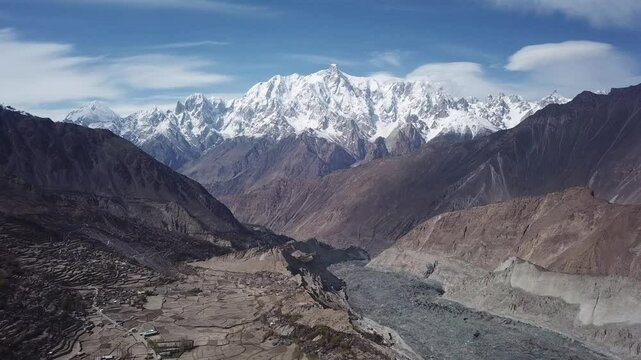 Aerial view of hoper glacier surrounded by majestic snow capped mountains in hopper valley, nagar khas, gilgit baltistan, pakistan.