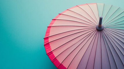 Pastel rainbow umbrella overhead shot on blue background.