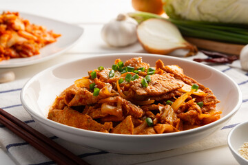 Stir Fried Kimchi with Pork.Stir fry sliced pork loin with cabbage kimchi in white plate.