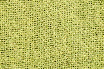 A piece of dyed jute fabric, macro, top view.