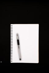 Blank Canvas: Spiral Notebook and Stylus on Minimalist Background