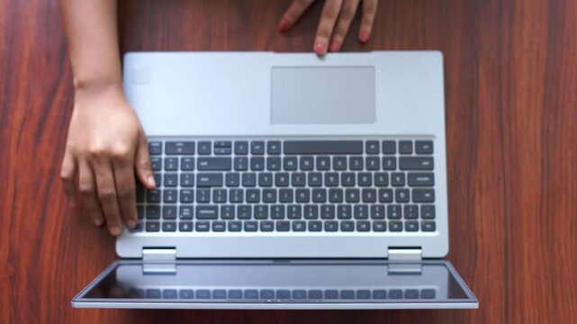 A close-up of turning on a laptop placed on a wooden table, captured in high-quality 4K video footage. Perfect for technology, workspace, and productivity-related content.