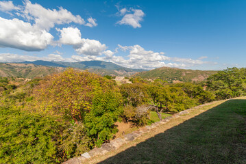 Architectural remains in Mixco Viejo, an ancient Mayan city, testimony of a great civilization, in the middle of green forests, ravines, under a blue sky.