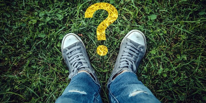 A pair of gray sneakers on green grass, with a question mark symbolizing curiosity.