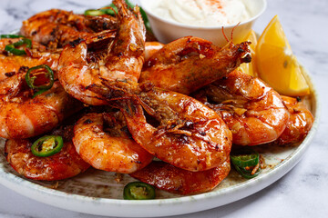 Grilled shrimps served with hot sauce and slices of fresh lemon, homemade, no people,