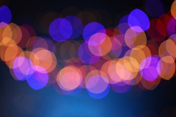 Blurred view of colorful lights on dark blue background, bokeh effect
