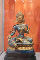 Close up of a sitting Buddha figurine in a lotus position.