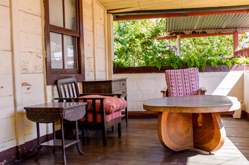 Interior of a traditional house, with colonial architecture. The architecture features thick walls, lush and colorful gardens, checkered tiles and organic wooden doors.