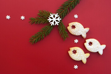 Christmas border with linzer cookies in a shape of fish, spruce twig and snowflakes, copy space for text