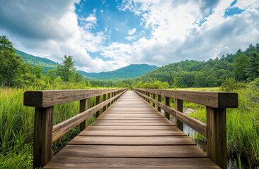 A wooden bridge stretches across a tranquil landscape, surrounded by vibrant greenery and mountains in the distance. The sky is dotted with fluffy clouds, creating a serene atmosphere.