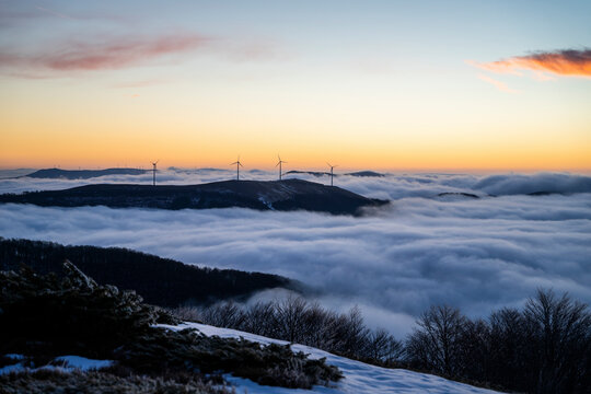 View of the balkan mountains with a wind turbine at sunset, Gabrovo, Bulgaria.