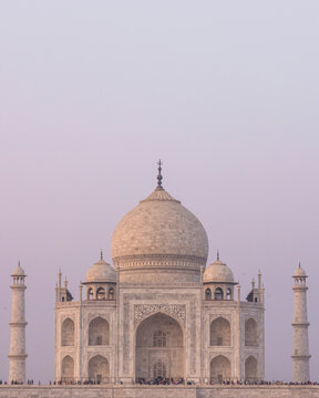 View of the iconic Taj Mahal with its elegant dome and minarets at sunset, Agra, India.