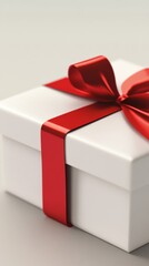 Fototapeta premium White gift box with red ribbon and bow on gray background