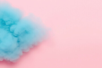 Naklejka premium A vibrant blue smoke cloud against a soft pink background, perfect for creative designs.