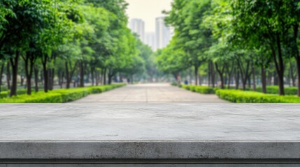 Fototapeta premium Empty marble table top with a blurred background of city street with green trees for product display montage and key visual concep