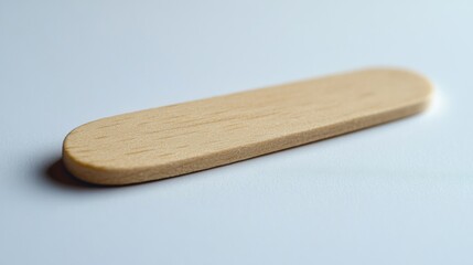 Smooth Wooden Stick on a Soft White Surface Natural Texture