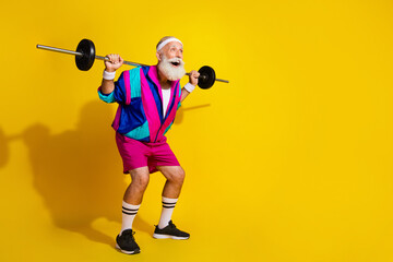 Full body photo banner of funny senior sportsman hold shoulders barbell squat dressed retro sport costume isolated on yellow background