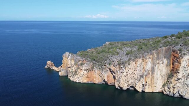 Majestic cliffs and turquoise waters at Playa Manare, Mochima National Park, Venezuela. A breathtaking drone view of coastal rock formations, lush vegetation, and pristine ocean scenery