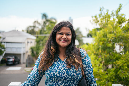 Portrait of a young smiling Indian woman outdoors