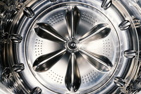 Close up detail of clothes washer machine drum while clean and empty